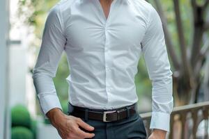 a young man in a white shirt posing in front of for mockup. photo