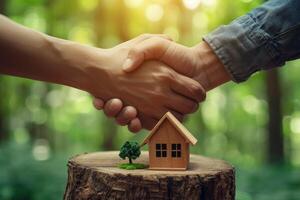 the real estate technology concept, of a real estate businessman holding a house and key given customer, selling house, house on background, table, working, photo