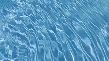 Blue water with ripples on the surface. Defocus blurred transparent blue colored clear calm water surface texture with splashes and bubbles. Water waves with shining pattern texture background. video