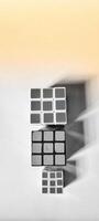 CENTRAL JAVA, INDONESIA. April 25th, 2024 - Portrait three Rubik's Cubes on white background morning sunlight concept. photo