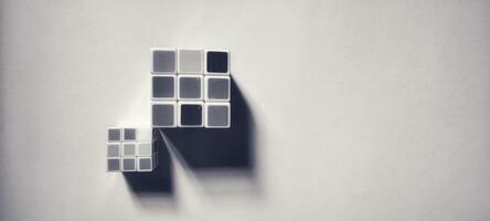 CENTRAL JAVA, INDONESIA. April 25th, 2024 - Black and white photo of two Rubik's cubes photographed by giving a shadow effect to the object.