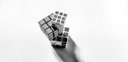 MAGELANG, INDONESIA. April 25th, 2024 - Black and white photo with an abstract photo concept. High angle view of three Rubik's cubes photographed by giving a shadow effect to the object