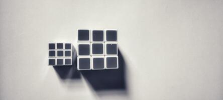 MAGELANG, INDONESIA. April 25th, 2024 - Black and white photo of three Rubik's photographed by giving a shadow effect to the object.