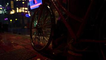 Bicycle Parked on Rainy Night in a Quiet Asian City video