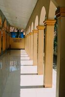 Mosque terrace with symmetrical pillars, showcasing elegant architecture and a serene ambiance photo