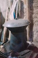 Traditional rice cooker on a wood-burning stove, capturing a rustic cooking method with flames from firewood photo