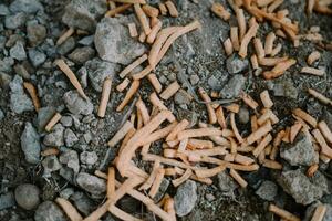 Discarded chiki sticks littering the street, creating an unsightly and wasteful scene photo
