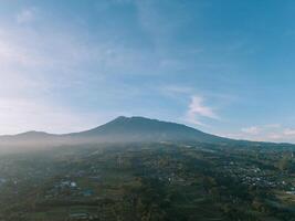 Morning view of Mount Gede with light mist and bright clouds, capturing serene and clear beauty photo