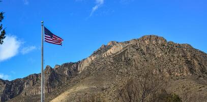 American flag against a blue sky in the territory of a visit center in a park in New Mexico photo
