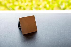 Mock up stainless menu frame, empty table tent stand on the table photo