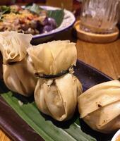 A delicious dish called Money Bag Dumpling is made from chopped chicken and shrimp wrapped in pastry shell photo