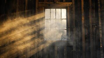 Sunlight filtering through dusty window of abandoned rustic barn photo