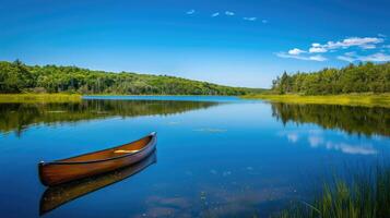Tranquil Reflections A Canoe Drifting on Glassy Waters photo