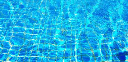 Wave or ripple water in swimming pool with sunlight reflection for background. Art or Abstract and Wallpaper concept. photo