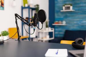 Close up of professional equipment for recording podcast in vlogger home studio. Influencer making social media content with production microphone and digital web internet streaming station photo