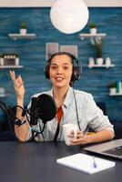 Content creator looking at camera while talking into microphone during beauty podcast. Creative online show On-air production internet broadcast host streaming live , recording digital social photo