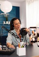 Vlogger on air during her podcast channel using mixer and professional microphone. Online show production internet broadcast host streaming live , recording digital social media communication photo