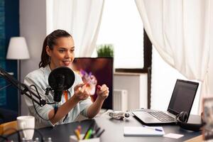 Beautiful vlogger making live make up tutorial share on social media using modern equipment. Influencer blogger sitting at the desk and recording blog where sharing advice for beauty community photo