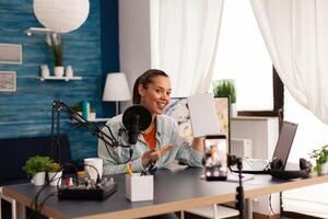 blogger recording talk show in home studio podcast using modern equipment. Creative content creator influencer vlogger making online series with giveaway for audience . photo