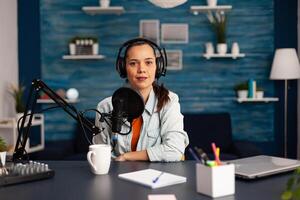 Famous blogger streaming from home studio podcast using professional recording equipment. Social Media content creator making fashion content for her channel where is sharing advice for beauty community photo