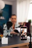 Creative vlogger and influencer filming a vr headphones review in professional studio podcast. Social media in digital internet web era recording new for online audience photo
