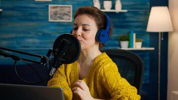 Famous blogger streaming from home studio putting headphones recording vlog. On-air online production internet broadcast show host streaming live content record digital social media communication photo