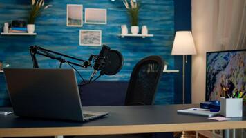 Empty podcast room with professional microphone in vlogger home studio in living. Influencer recording social media content with production microphone, digital web internet streaming station photo