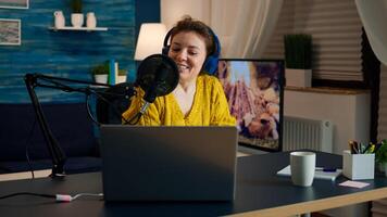 Influencer wearing headphones recording new podcast series for audience. On-air online production internet broadcast show host streaming live content for digital social media using internet web photo