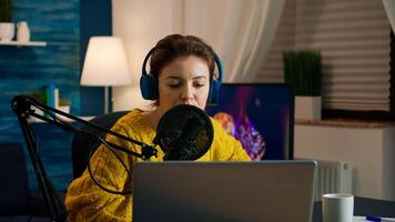 Blogger opening laptop starting to talk with followers recording new podcast at home studio. On-air online production internet broadcast show host streaming live content, recording digital vlog photo