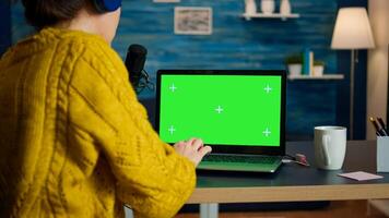 blogger reading emails on laptop with green screen display during broadcast. Creative online show On-air production internet broadcast host streaming live content using chroma key laptop photo