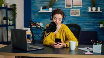 Influencer using laptop while talking with followers during live on social media. Creative online show On-air production internet broadcast host streaming live content, recording digital vlog photo
