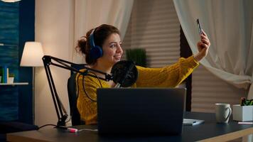 Entertainment blogger doing selfie during broadcast working from home studio. On-air online production internet podcast show host streaming live content, recording digital social media communication photo