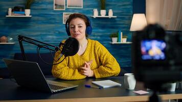 Blogger speaking about life during podcast in home studio looking at camera. Online show On-air production internet broadcast host streaming live content, recording digital social media communication photo