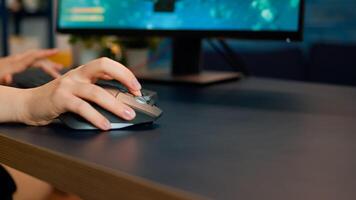 Close up hands shot of gamer pushing the keyboard buttons while playing online shooter game. Virtual championship in cyberspace, esports player performing on pc during gaming tournament photo
