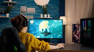 Professional eSports gamer skilfully plays 3D shooter mock-up game with super action and special effects on computer using headset. Cyber performing on powerful pc in stylish room photo