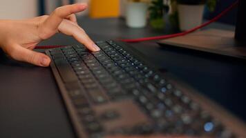 Close-up on hands of woman gamer playing game using RGB keyboard. Virtual championship in cyberspace, esports player performing on pc during gaming tournament using technology network wireless photo