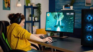 Back shot of happy gamer playing and winning space shooter online game on powerful personal computer. Online streaming cyber performing during gaming tournament using technology network wireless photo