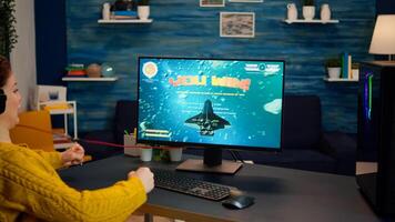 Professional esports gamer playing on computer game, happily and cheerfully celebrates victory and success. Online cyber gaming tournament live streaming event using technology network wireless photo
