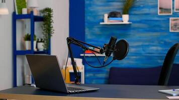 Online live podcast studio desk with microphone in home studio of vlogger. Influencer recording social media content with production microphone. Digital web internet streaming station photo