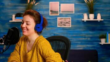Famous young woman recording a vlog for subscribers using podcast microphone for vlogging. On-air online production internet broadcast show host streaming live content for social media photo