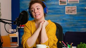 Influencer making online internet content for web subscribers in home podcast studio during livestreaming. On-air online production internet broadcast show host streaming live content for social media photo