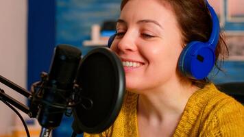 Famous vlogger making an online podcast recording for virtual show. Influencer using headphones speaking at microphone for radio program, On-air production internet broadcast show host streaming photo