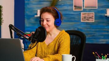 Influencer vlogger looking at laptop while asking audience to subscribe on channel. Creative online show On-air production internet broadcast host streaming live content recording digital social media photo