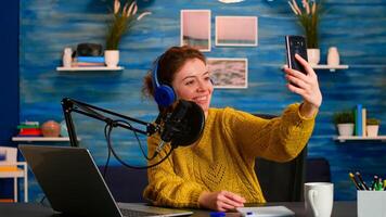 Entertainment podcaster taking selfie during broadcast working from home studio. On-air online production internet podcast show host streaming live content, recording digital social media communication photo