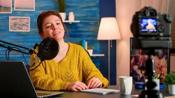 Blogger influencer recording blog concept speaking looking at camera on tripod in home podcast studio. Social media vlogger shooting vlog, streaming online broadcast using internet web photo