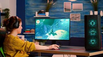 Streamer sport gamer playing game with RGB keyboard putting on headset. Virtual space shooter championship in cyberspace, esports player performing on computer in stylish room during gaming tournament photo