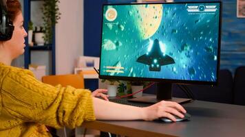 Woman gamer playing esports from home using powerful computer participating at championship. Virtual shooter game in cyberspace, esports player performing on pc gaming tournament photo