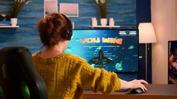 Professional gamer playing and winning in space shooter online game on powerful computer. Pro esports player streaming cyber performing gaming tournament in cyberspace using network wireless photo