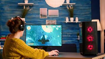 Excited player winning an important virtual egame competition of space shooter game playing on powerful computer. Pro gamer streaming cyber performing gaming tournament in cyberspace photo
