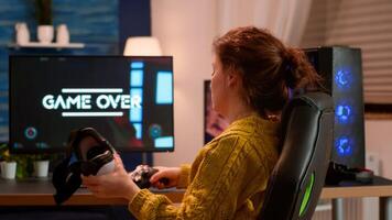 Experienced gamer wearing VR playing at home game using wireless controller, relaxing at night. Online streaming cyber performing on powerful personal computer during gaming tournament photo